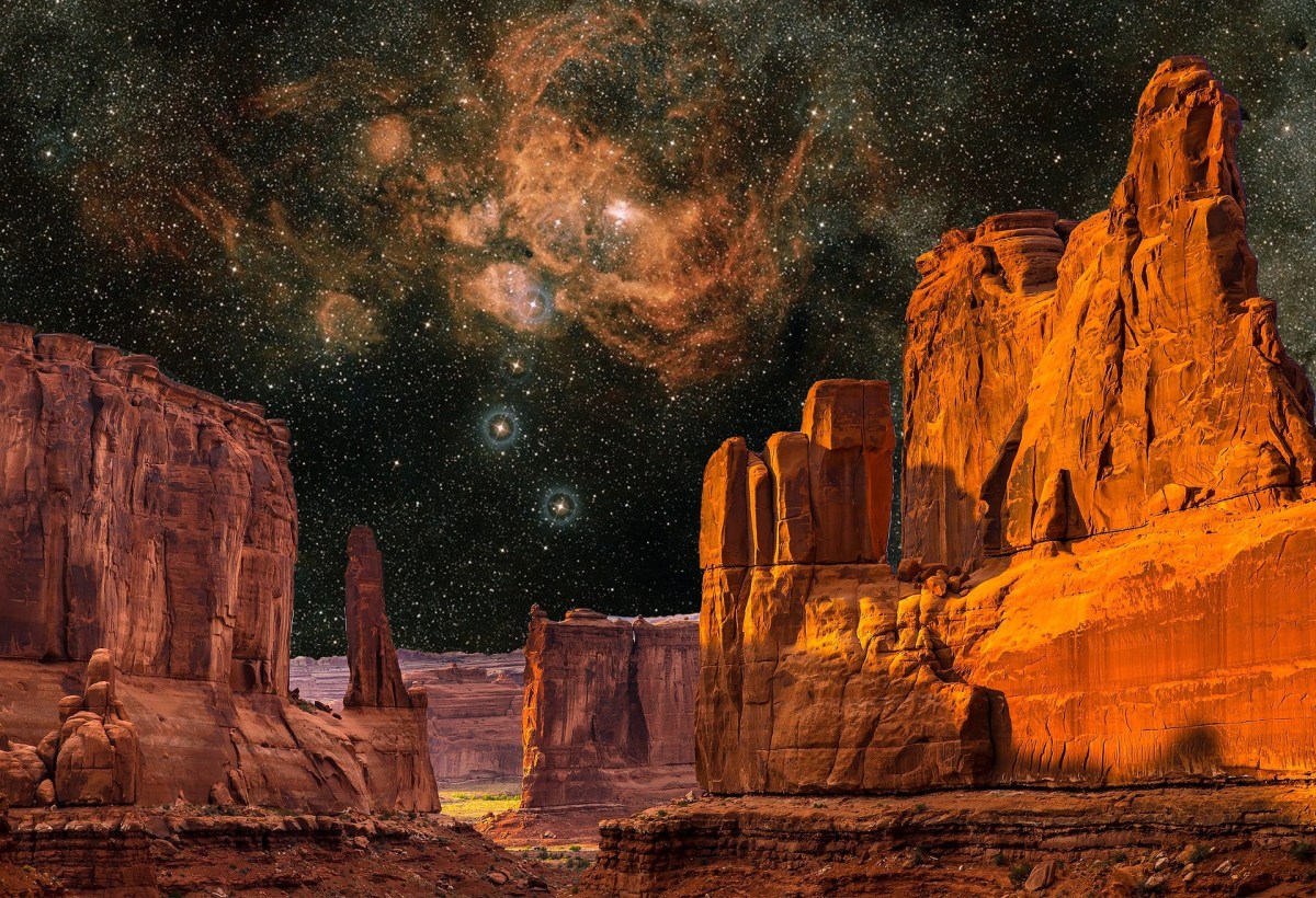 a grand, red canyon, brilliantly lit -- above, a starry night sky showing all the crevices and dust and wisps of a galaxy.